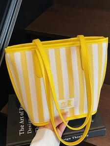 Large capacity tote bag featuring vibrant yellow striped woven fabric and leather handles