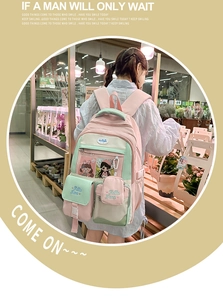 Detail of pink and mint green nylon backpack with transparent window and embroidery