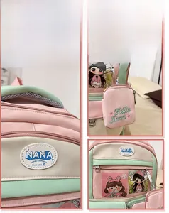 Detail view of the pink and green backpack featuring NANA embroidery and transparent pocket