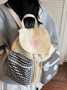 Japanese style canvas backpack in beige with patchwork pockets and pink heart detail