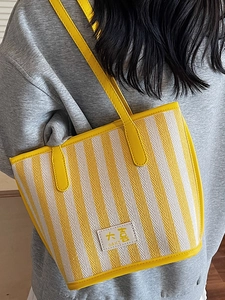 Minimalist yellow striped canvas tote bag with leather trim and shoulder strap