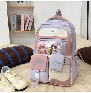 Detail of purple and pink ita bag with transparent PVC pocket and Hello Nana embroidery