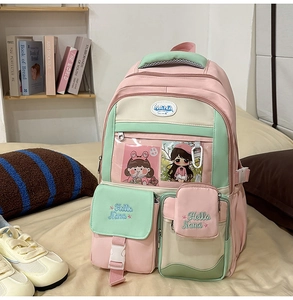 Detail view of pink and mint green nylon backpack with transparent pocket and embroidery
