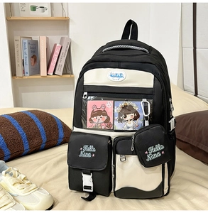 Detail of black and white school backpack with transparent card slot and Hello Nana embroidery
