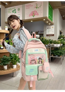Detail view of pink and green contrast backpack with clear pocket and Nana embroidery