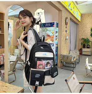 Detail of a black and white backpack with Hello Nana embroidery and accessory pouch
