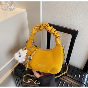 Detail of yellow cloud bag with ruched handle, silver chain and white plush charm