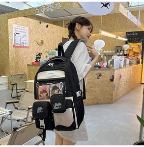 Detail of black and white contrast backpack with transparent window and Hello Nana embroidery