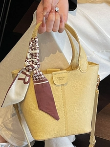 Classic yellow lychee leather bucket bag with houndstooth silk scarf and shoulder strap