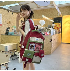 Detail of color-block backpack with transparent insert pocket and mini zipper pouch