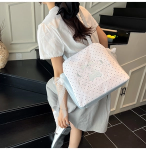 Detailed close-up of lace edge with rabbit embroidery and polka dot on sweet canvas bag