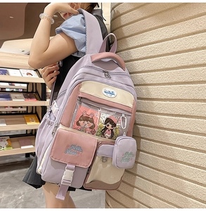 Detail view of purple and pink backpack showing the transparent heart window and front pocket