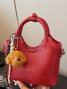 Fashionable red oily leather bucket tote bag with cute teddy charm and top handle