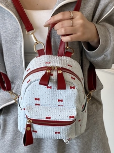 Mini sac à dos blanc avec imprimés nœuds rouges et bretelles en cuir rouge