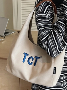 Sac fourre-tout en toile beige avec broderie bleue et détails en cuir pour le bureau