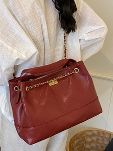 Fashionable red quilted leather tote bag with gold chain strap and diamond pattern