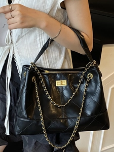Retro black quilted leather tote bag with gold chain strap and elegant metallic twist lock