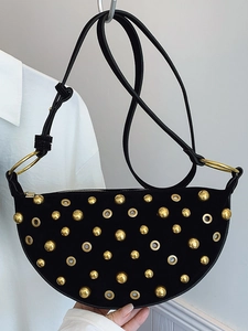 Chic black crescent shoulder bag with gold metal studs and adjustable leather strap