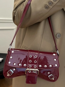 Chic burgundy patent leather underarm bag with silver rivets and metal buckle design