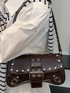 Y2K vintage dark brown patent leather shoulder bag with silver studs on model