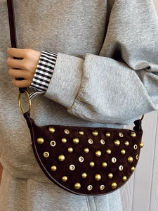 Brown suede crescent bag featuring vintage gold studs and rivets in a punk style