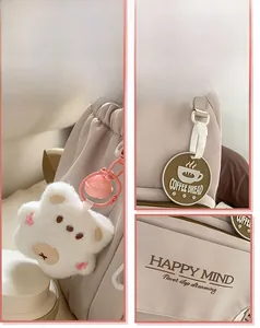 Detail of cream canvas backpack with plush bear pendant and motivational slogans