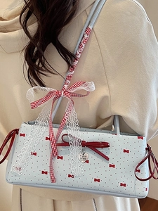 Blue rectangular shoulder bag with red bows, polka dots, and lace ribbon decoration
