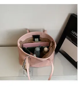 Interior view of pink woven tote bag showing large capacity for tablet and daily items