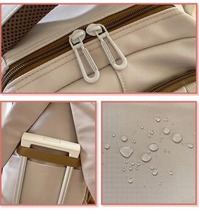 Detail of waterproof beige backpack showing dual zippers and luggage trolley sleeve strap