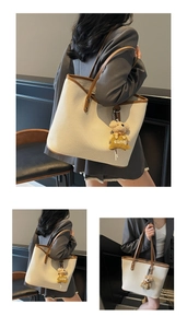 Detailed views of the cream tote bag with brown leather trim and a small bear pendant