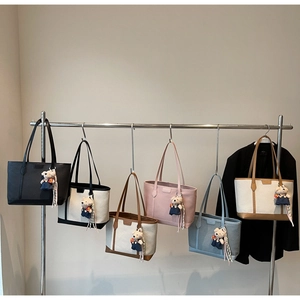 Detail view of large tote bags in six colors with woven texture and cute bear charms