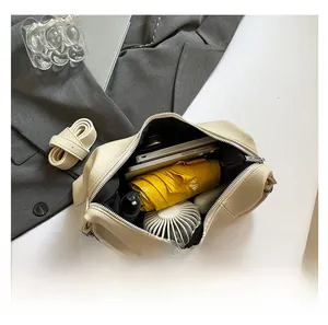 Top-down view of the spacious beige leather bag interior showing daily essentials storage