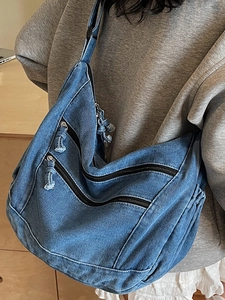 Blue washed denim hobo bag featuring triple parallel zippers and large capacity design