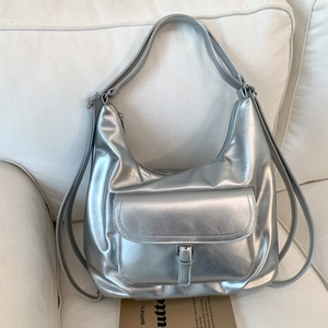 Close-up of metallic silver tote bag with front pocket and adjustable shoulder straps