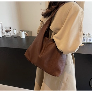 Deep brown litchi pattern PU leather hobo bag styled in a cozy cafe setting
