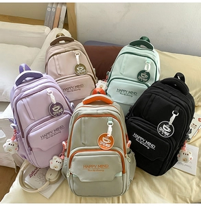Flat lay of colorful school backpacks in purple pink green gray and black options