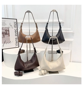 Detail of four hobo bags in caramel, black, coffee and cream with pebble leather texture