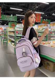 Detail of lavender high school backpack with cute bear pendant and Happy Mind logo
