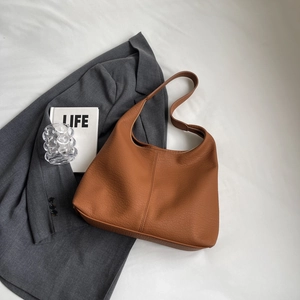 Detailed macro view of the brown litchi grain texture on this vintage hobo shoulder bag
