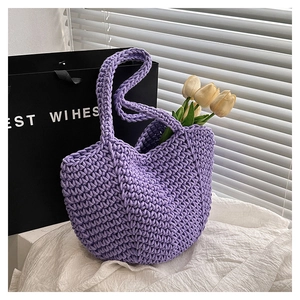 Detailed close-up of purple hand-woven tote bag with thick knit texture and wide opening