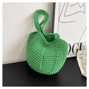 Macro detail of bright green crochet tote bag featuring thick woven herringbone textures