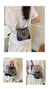 Chic grey canvas bucket bag with black leather trim and adjustable strap in various angles