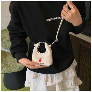Detail of cute puppy embroidery on cream yellow plaid mini crossbody bucket bag