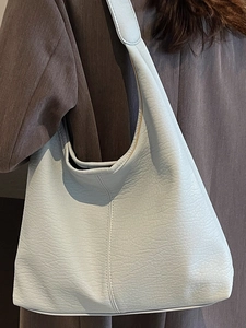Fashion light blue tote bag with lychee texture and vertical stitching on model