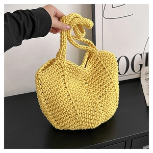 Close-up of vibrant yellow handmade crochet tote bag with intricate woven texture