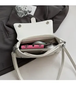 Detail view showing large interior capacity with zipper pocket in white baguette bag