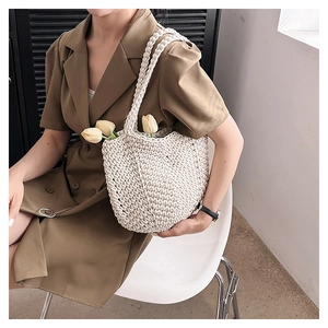 Detailed close-up of a handmade crochet tote bag in beige with intricate woven texture