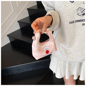 Detail of pink plaid bucket bag with ruffle handle and cute puppy embroidery design