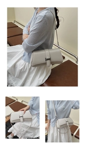 Detail of minimalist cream baguette bag featuring silver buckle and vegan leather texture