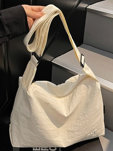 Minimalist beige large capacity canvas crossbody bag with adjustable wide strap and ANT logo